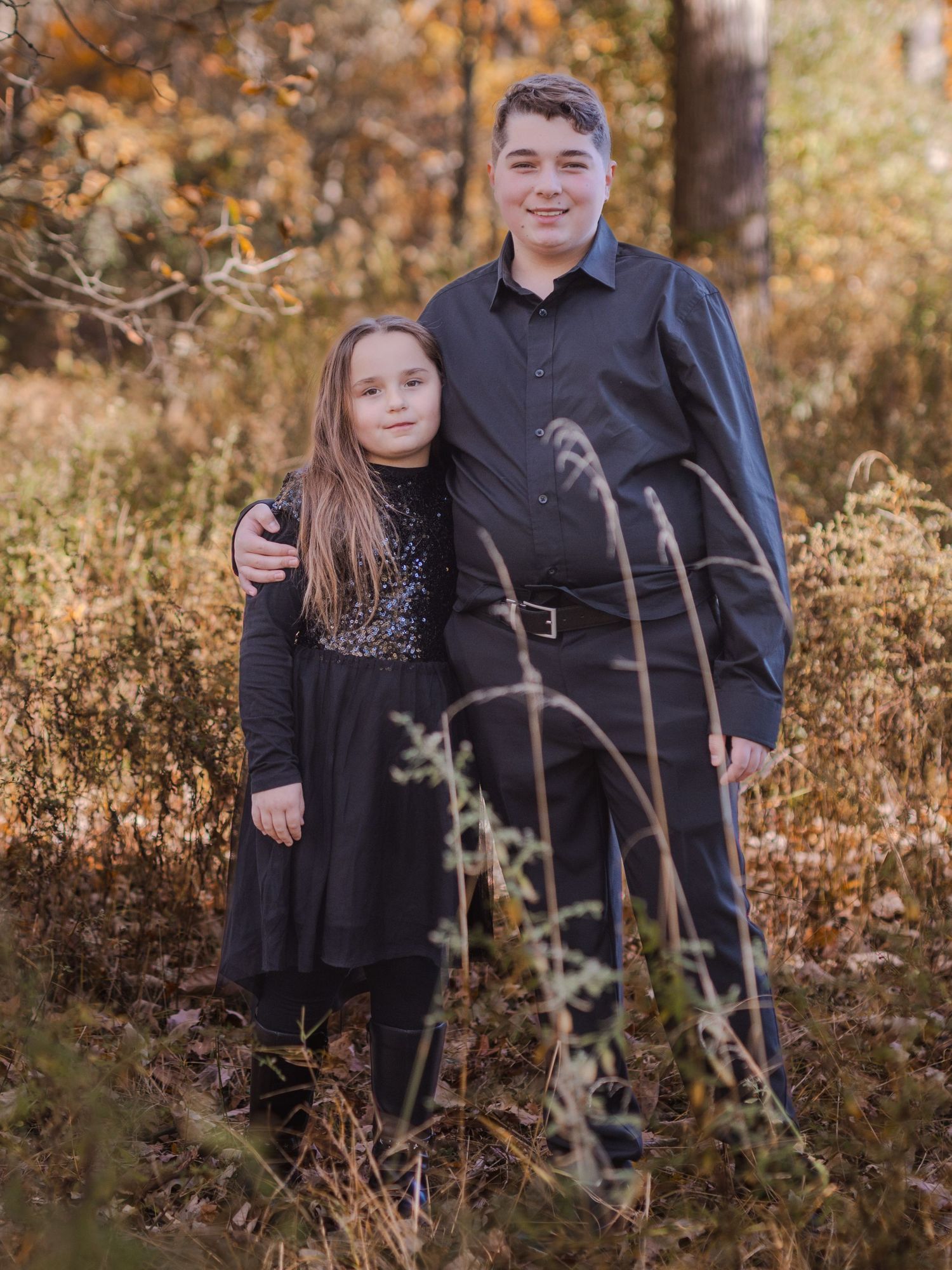 Kids fall photoshoot in Windsor Ontario with black clothing and colorful autumn foliage, photographed by Tasha Cannaday.