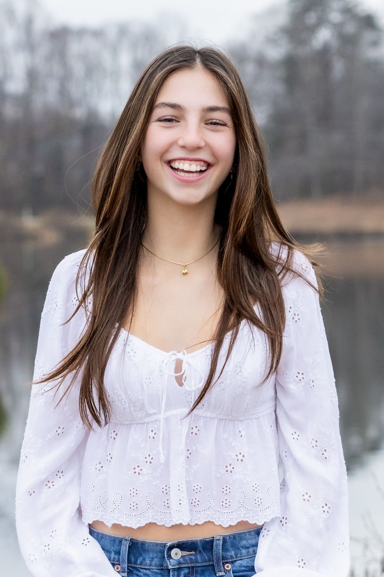 Teen girl smiling confidently during golden hour portrait session in Windsor, Ontario by Tasha Cannaday.