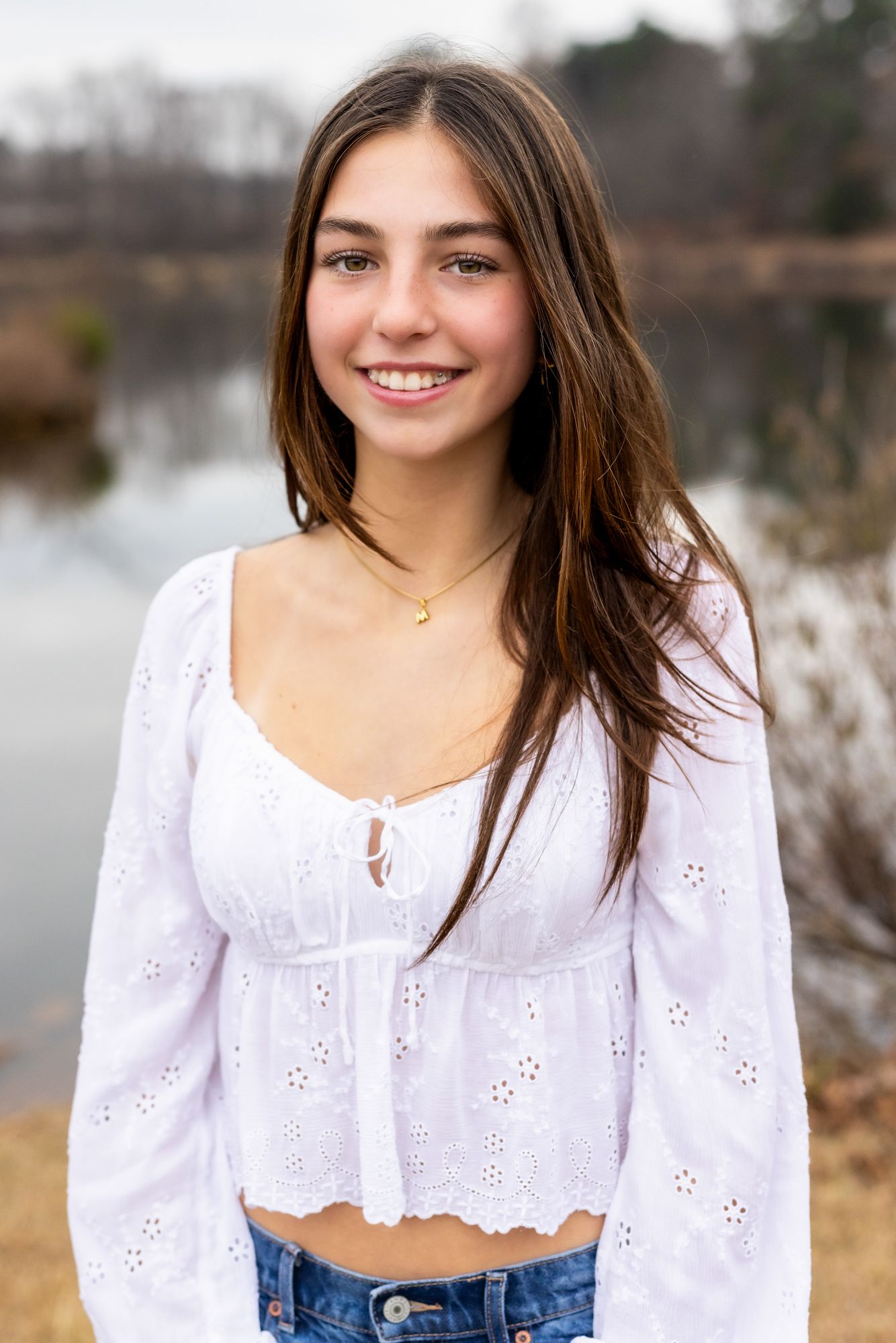 Teen girl smiling confidently during golden hour portrait session in Windsor, Ontario by Tasha Cannaday.