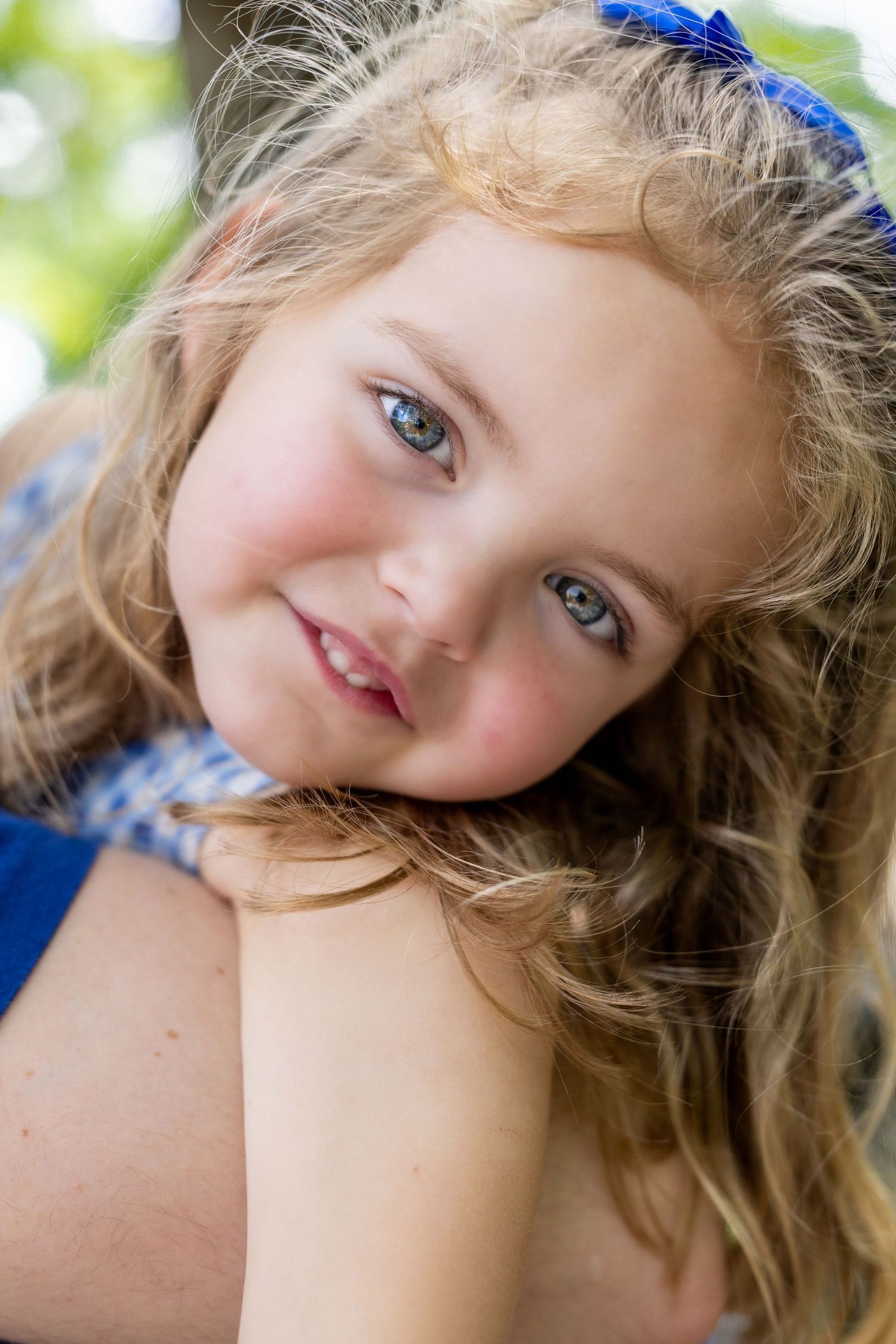 Childhood portrait near water during summer sunset, taken in Amherstburg by Windsor photographer.