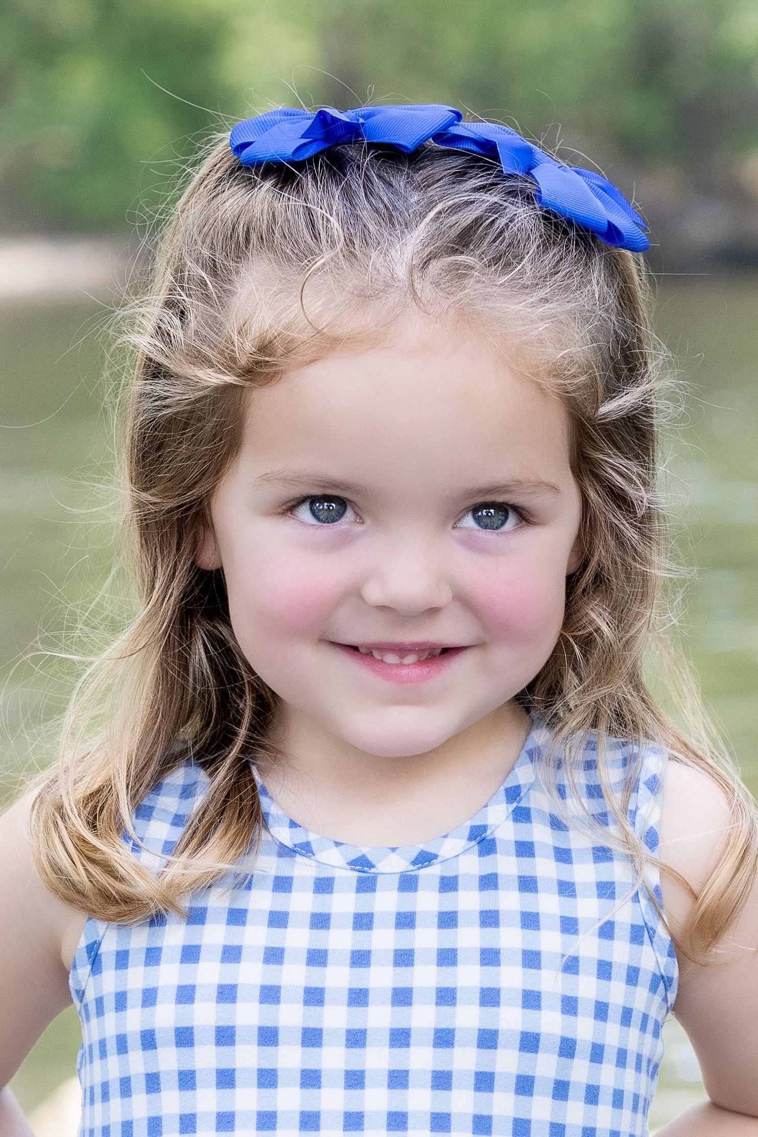 Child portrait near water during summer sunset, taken in Amherstburg by Windsor photographer.
