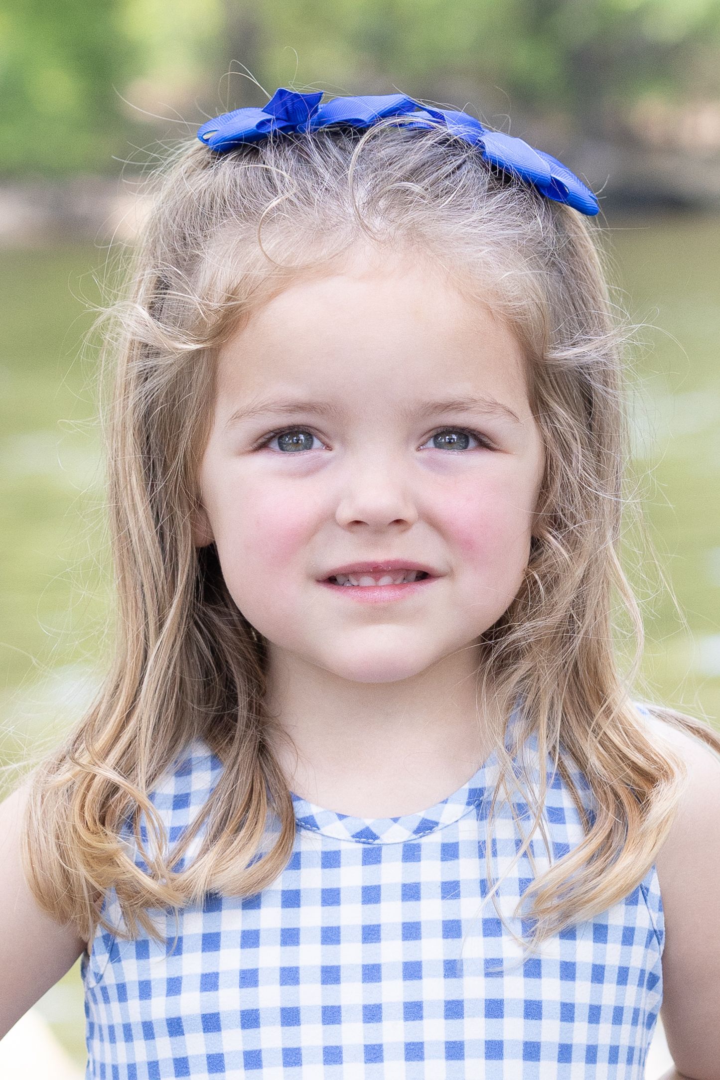 Childhood portrait by the water during summer, taken in Amherstburg by Windsor photographer.