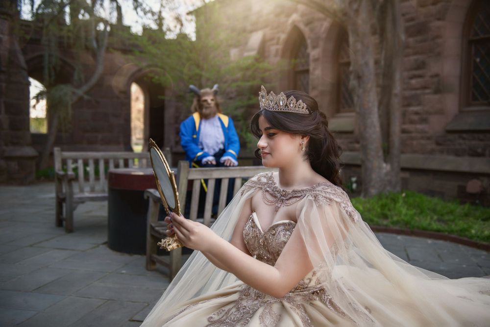 Beauty and the beast theme quinceanera sweet 16 Belle looking at herself in the mirror while Beast looks at her from far away