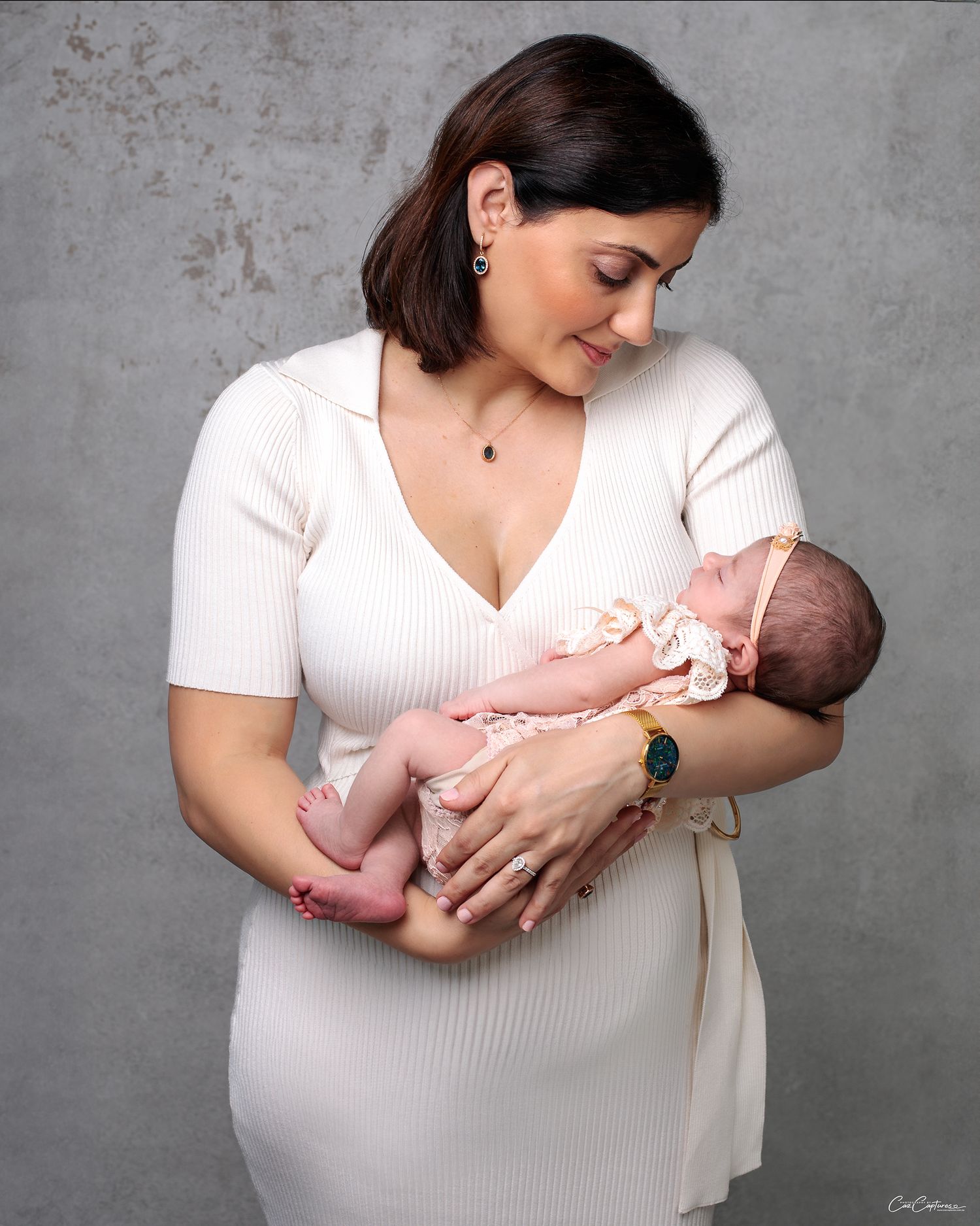 Close Up of a mother holding her newborn daughter by Sydney based Newborn and Family photographer Caz Captures.