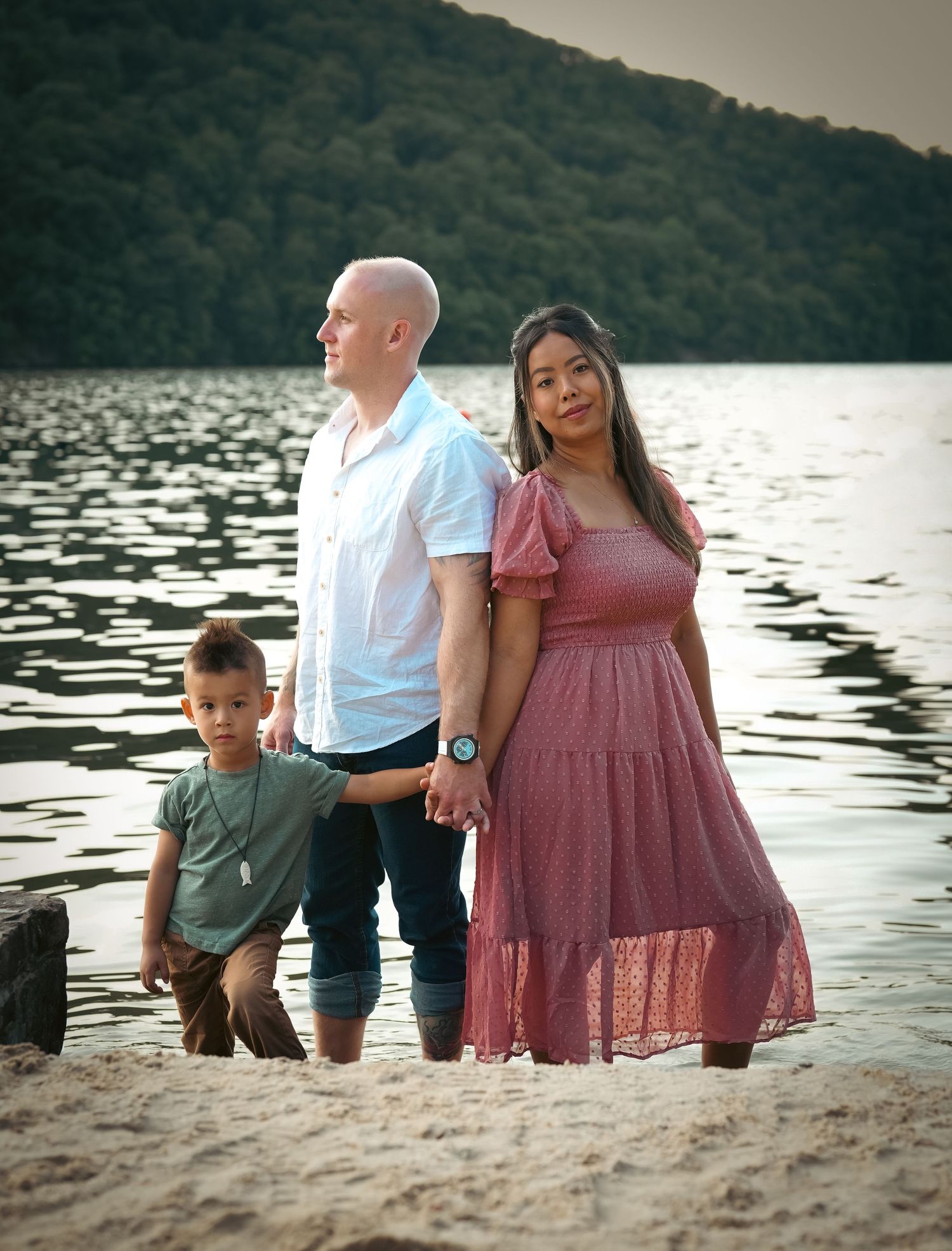 Family portrait session at sunset by a serene lake.