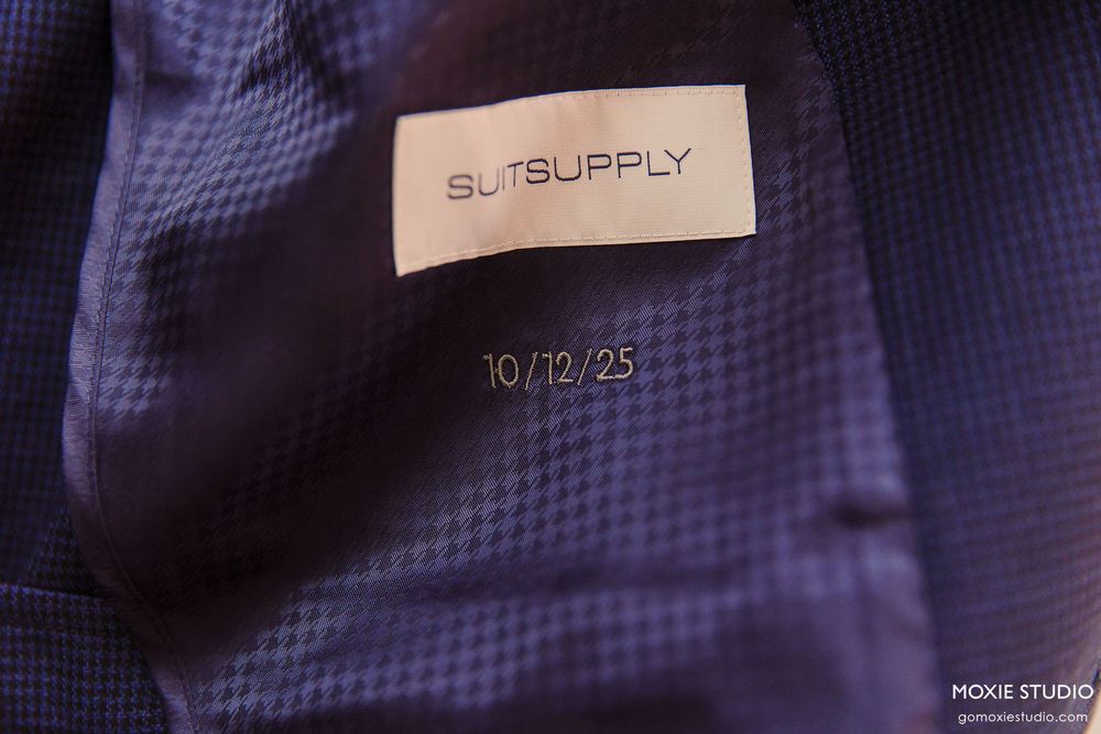 A purple plaid fabric texture with repeating checkered pattern shows close-up detail of woven material.