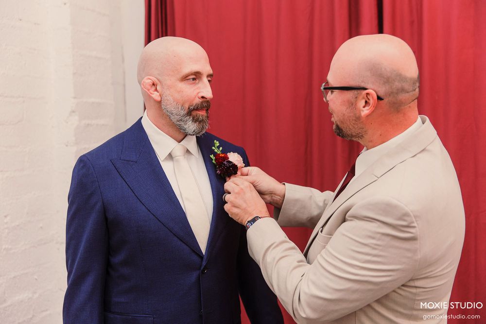Series of wedding ceremony moments showing two people exchanging rings in front of red curtains.