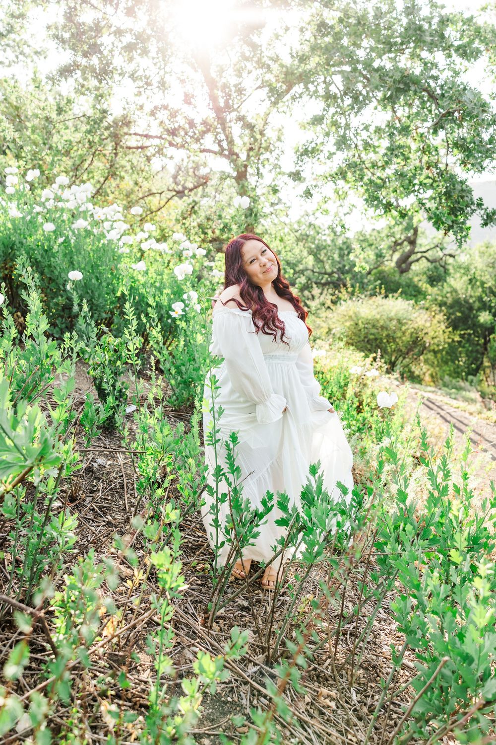Royal High School senior posing at Conejo Valley Botanical Gardens in Ventura County, capturing natural light and joyful outdoor portraits.