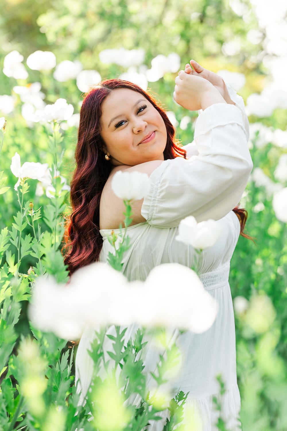 Royal High School senior posing at Conejo Valley Botanical Gardens in Ventura County, capturing natural light and joyful outdoor portraits.