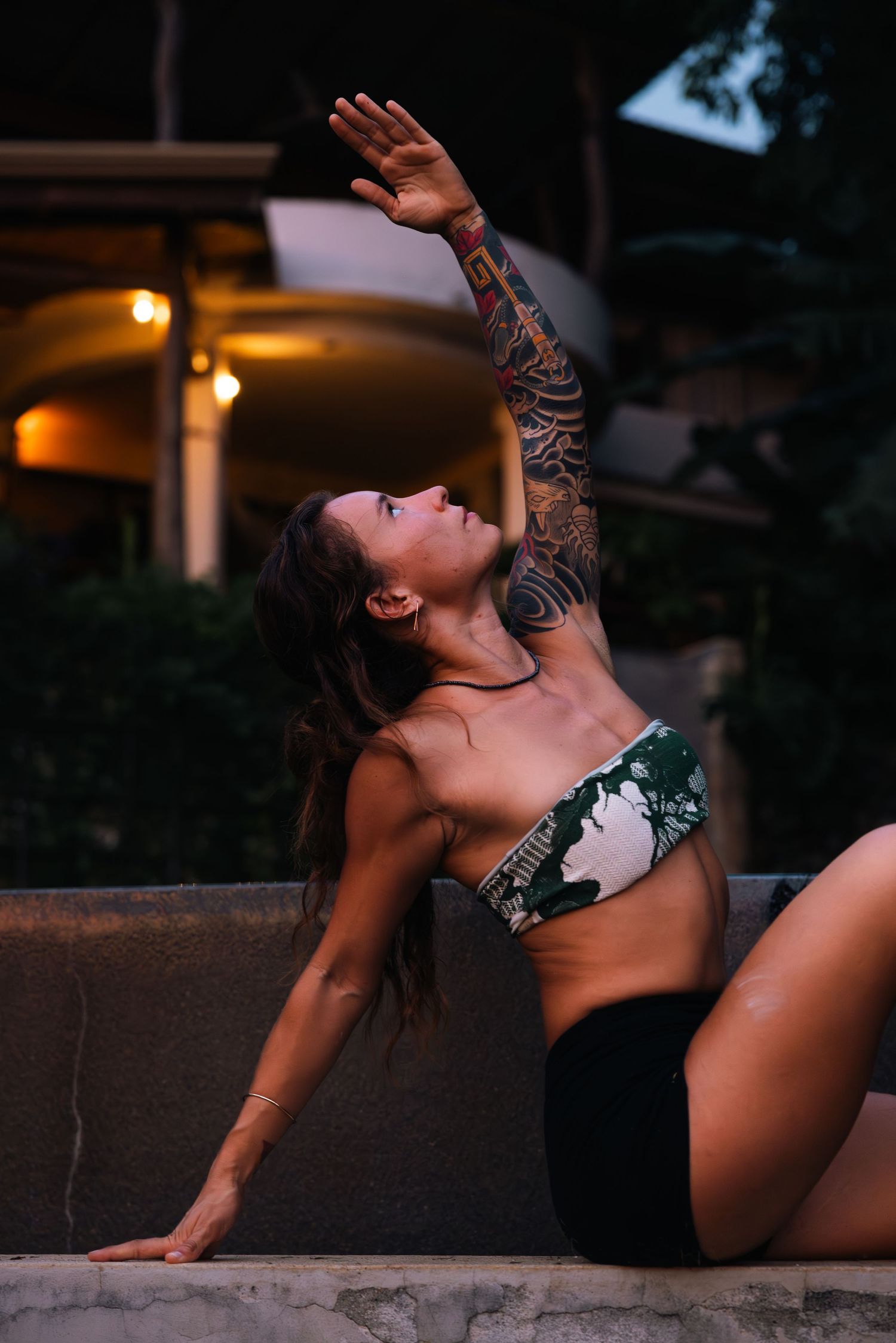 Contemporary dance poses captured against concrete wall in evening light.