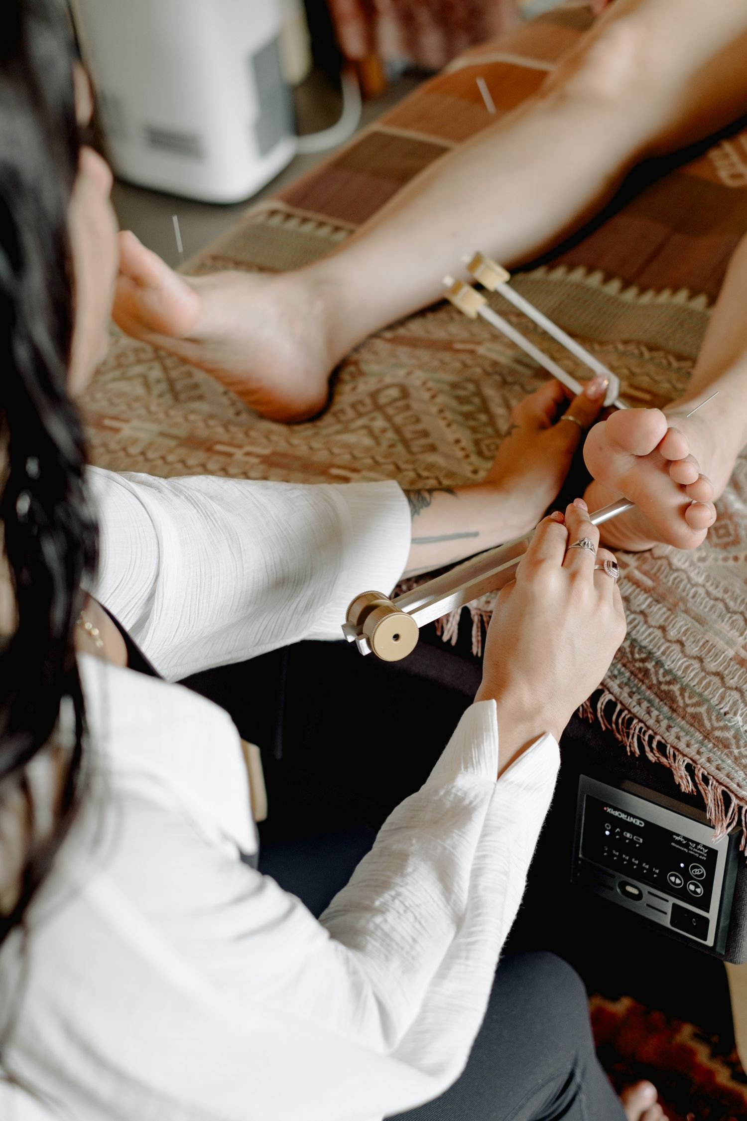 Close-up shots of hands working with white fabric and sewing materials.