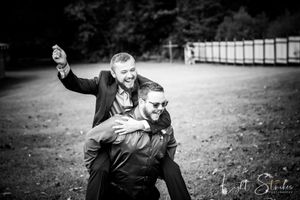 A series of black and white candid photographs showing playful outdoor moments in a farm wedding setting.