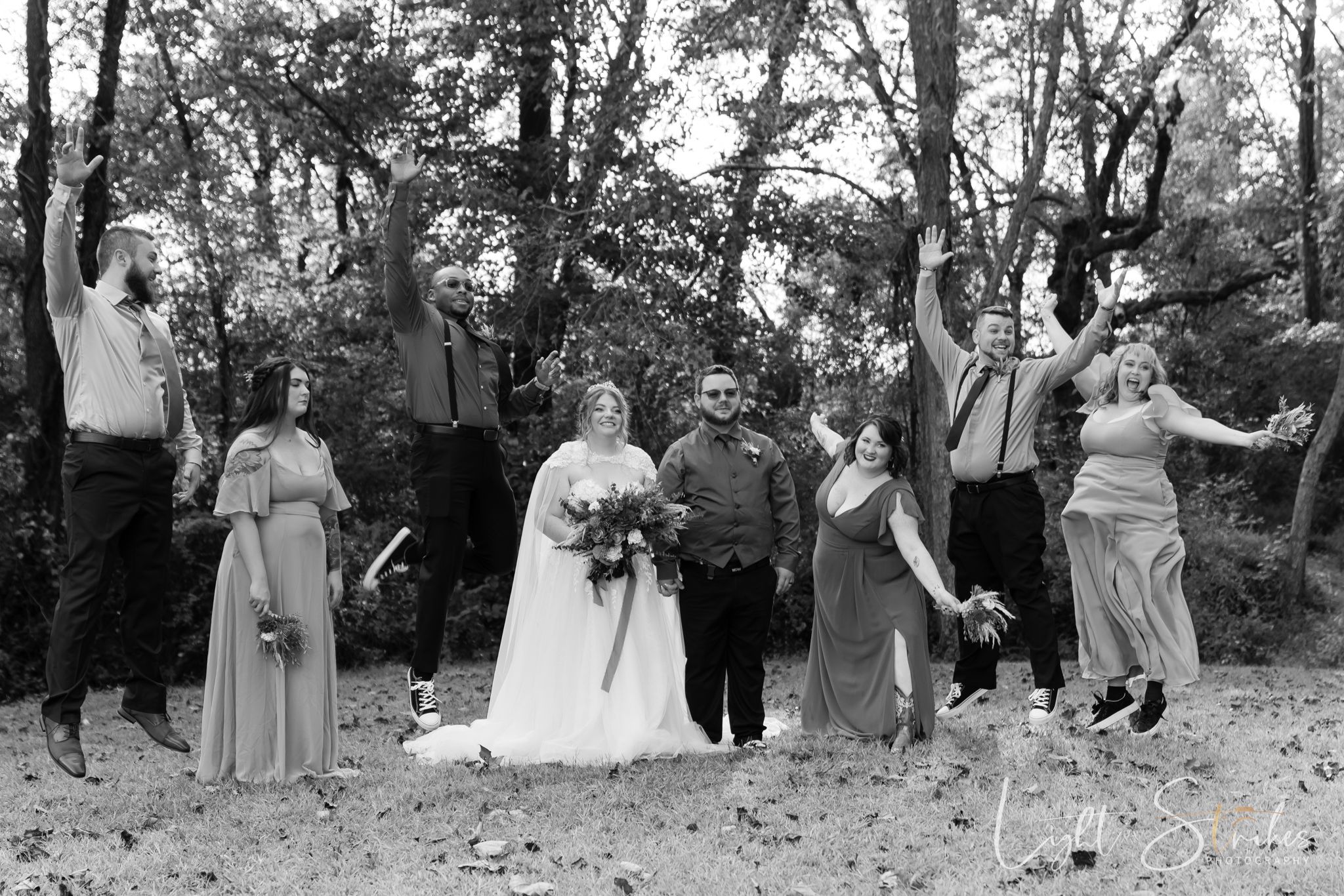 A wedding party having fun in an outdoor farm wedding setting in north Carolina outdoor farm wedding.