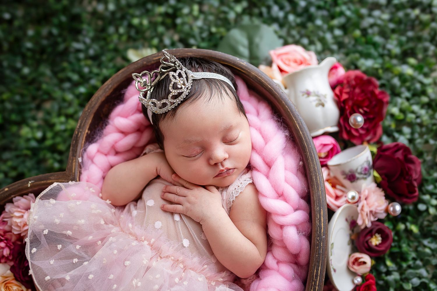 Newborn princess style photography in Ponce Puerto Rico baby girl sleeps in a heart shaped bowl