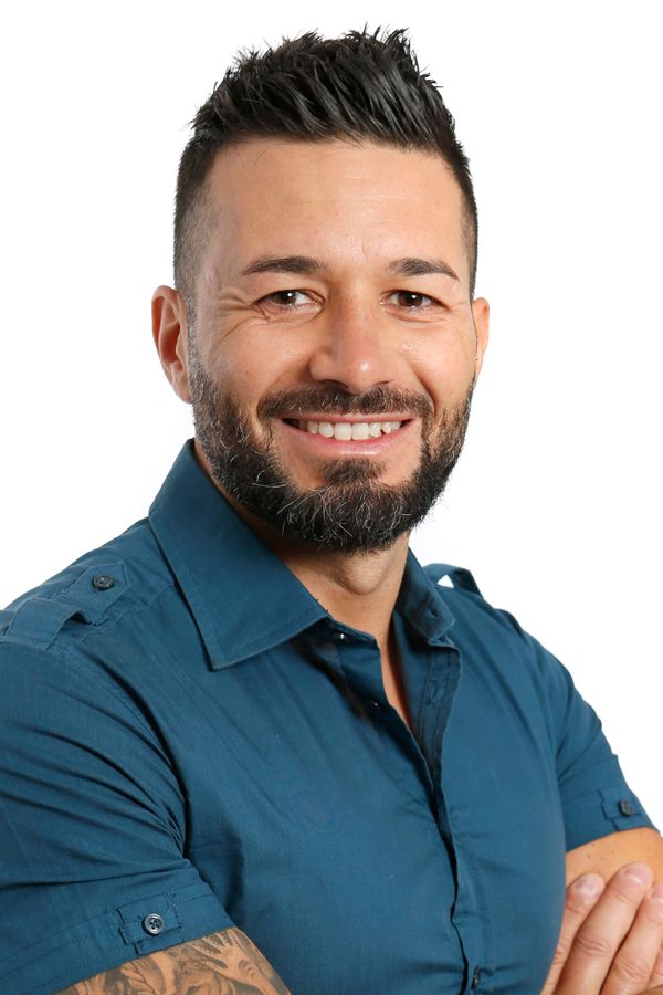 Professional headshots showing different expressions in a blue collared shirt against a light background.