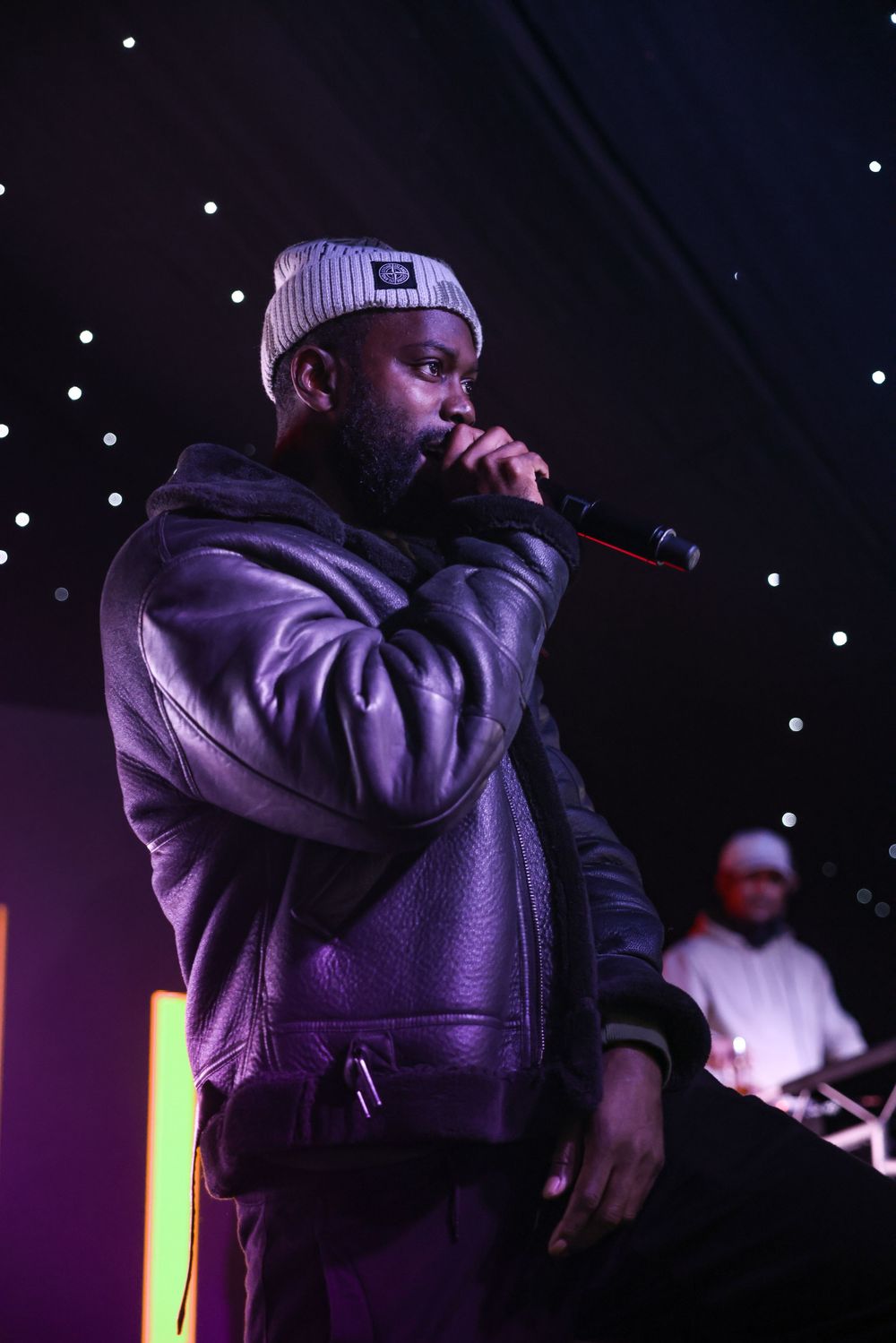Event photography of The Real Gheets Performer Rapping on stage during event.