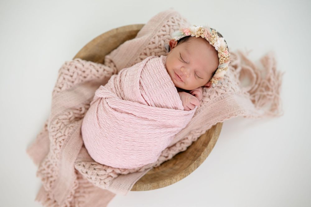 Collage of newborn photography with soft pink wraps and delicate lace textures against neutral backgrounds.