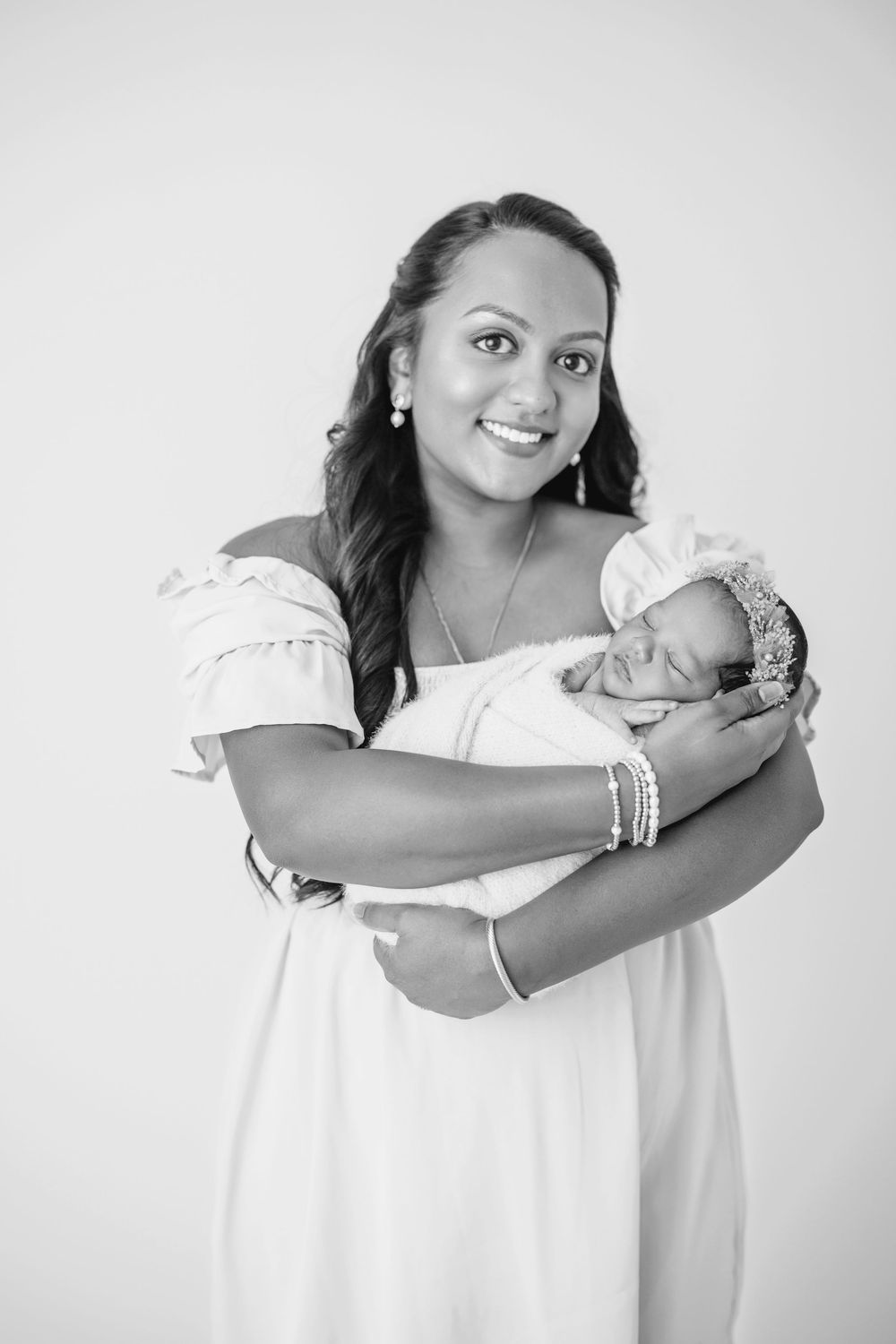 Black and white portrait series showing a person in white clothing posing against a light background.