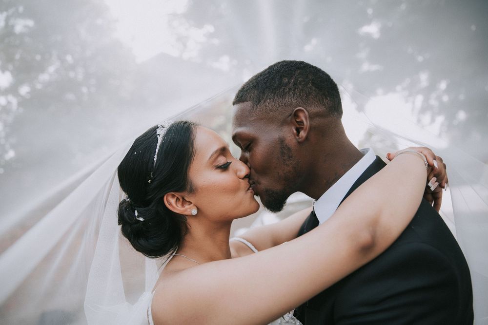Romantic wedding portrait series with soft lighting and ethereal veil movement.