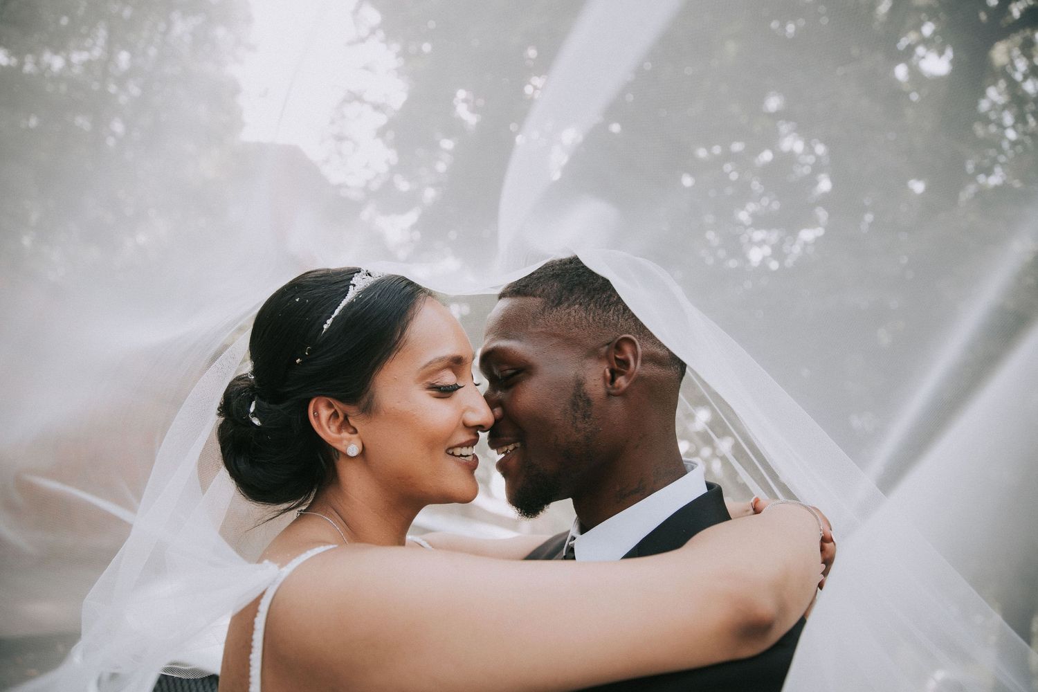 Romantic wedding moments captured in dreamy black and white photography with soft natural lighting.