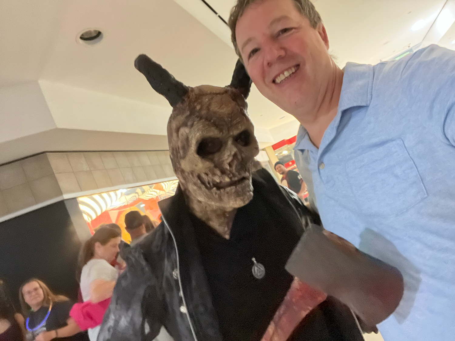 A person wearing a realistic werewolf mask poses in multiple selfie-style photos with a playful expression.