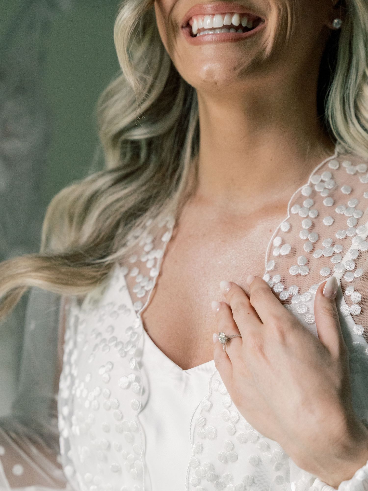 Close-up shot of wedding dress with intricate floral lace details.