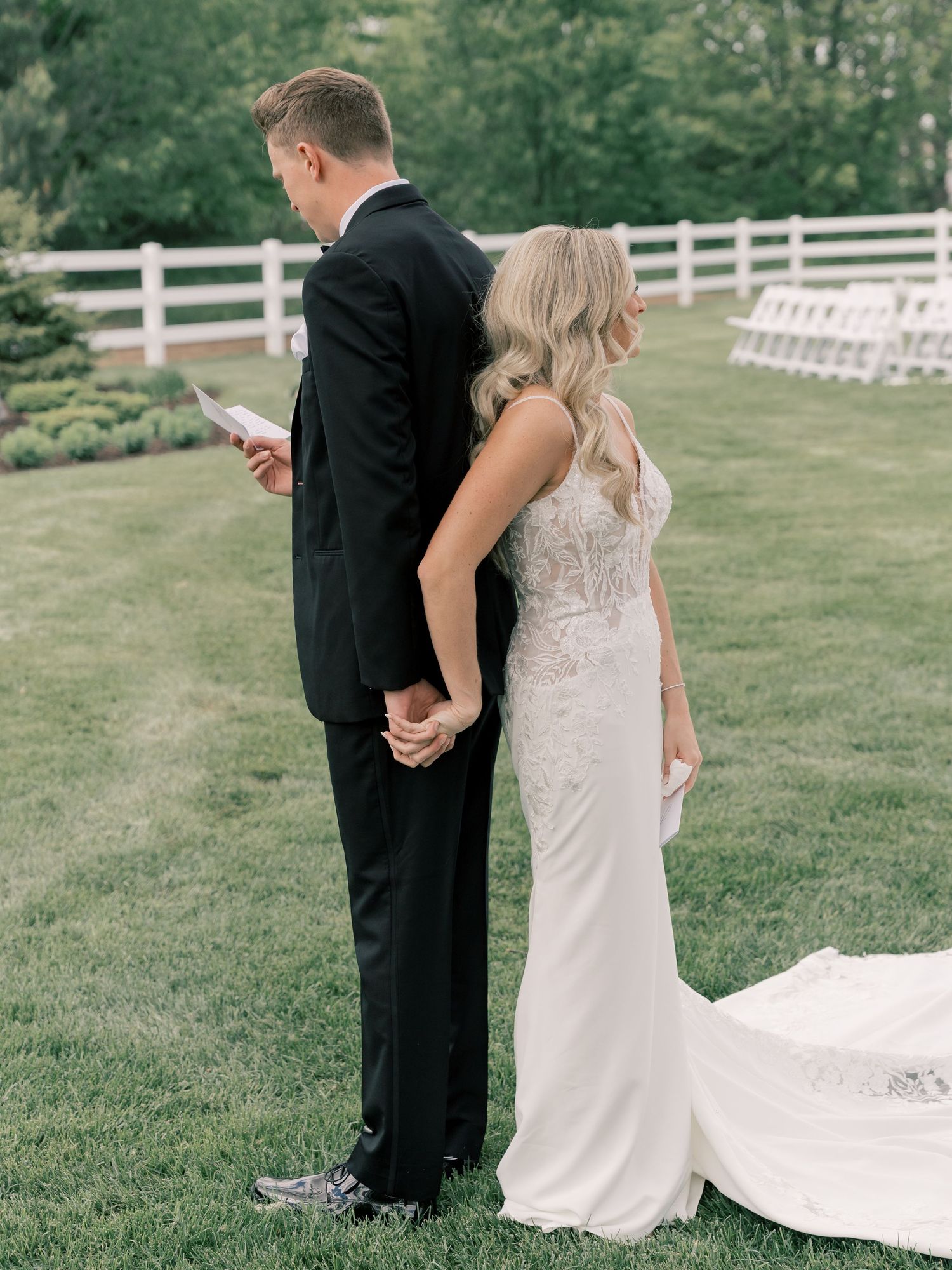 Romantic first look wedding moment captured in an outdoor garden setting.