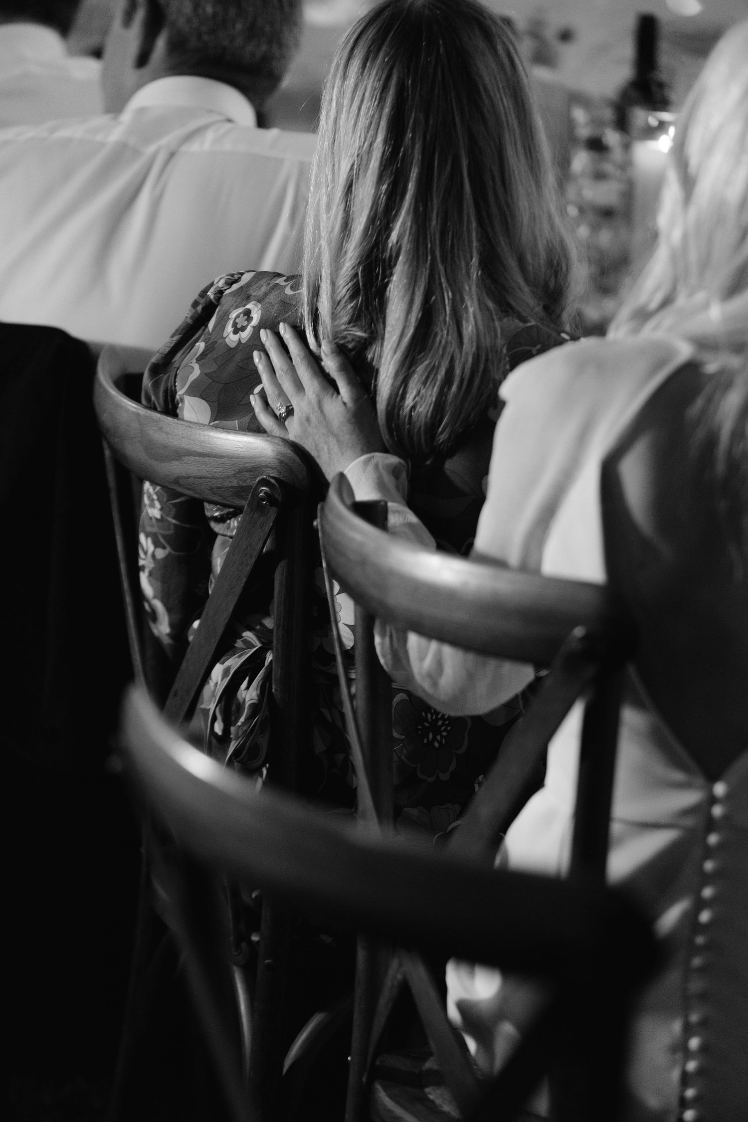 Black and white sequence showing hair being styled with professional tools and techniques at a salon.