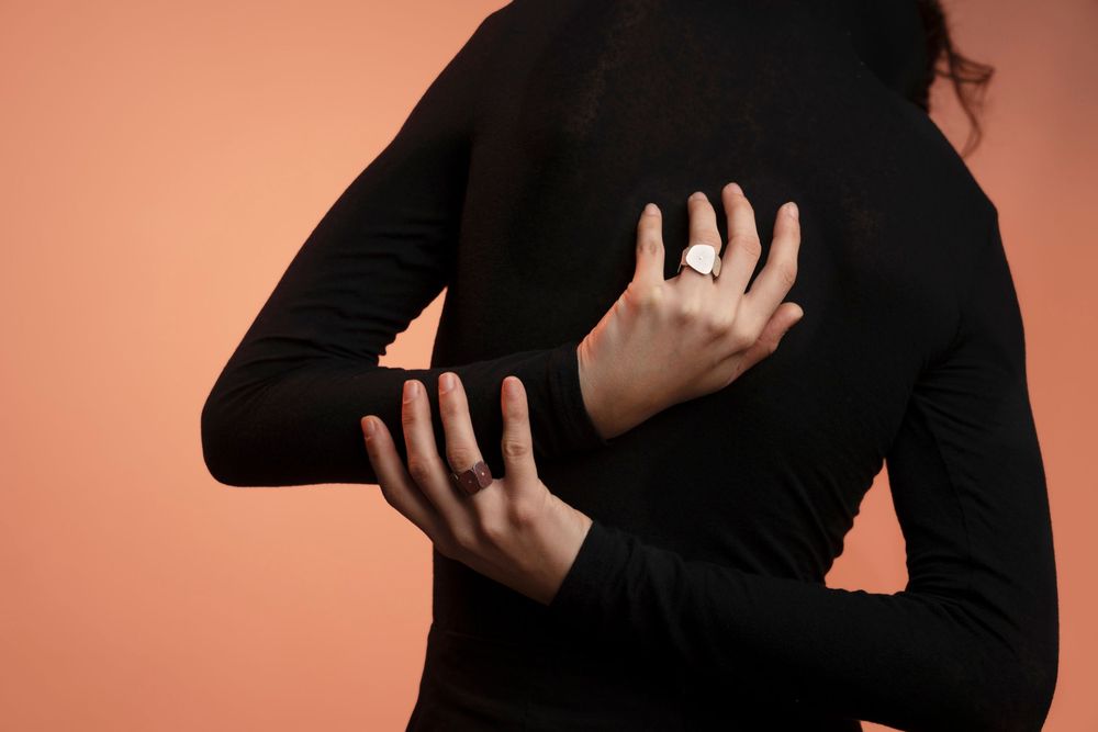 Woman in a black turtleneck showcasing silver rings; Winter collection lookbook photography based in Florence.