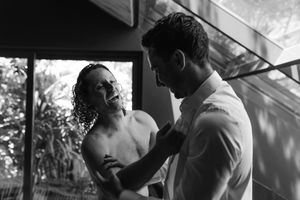 A series of romantic black and white photos showing tender moments between a couple in intimate poses.