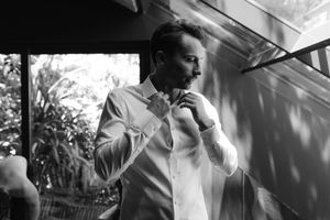 Black and white photo series showing a person smoking a cigarette while seated near a window in moody lighting.