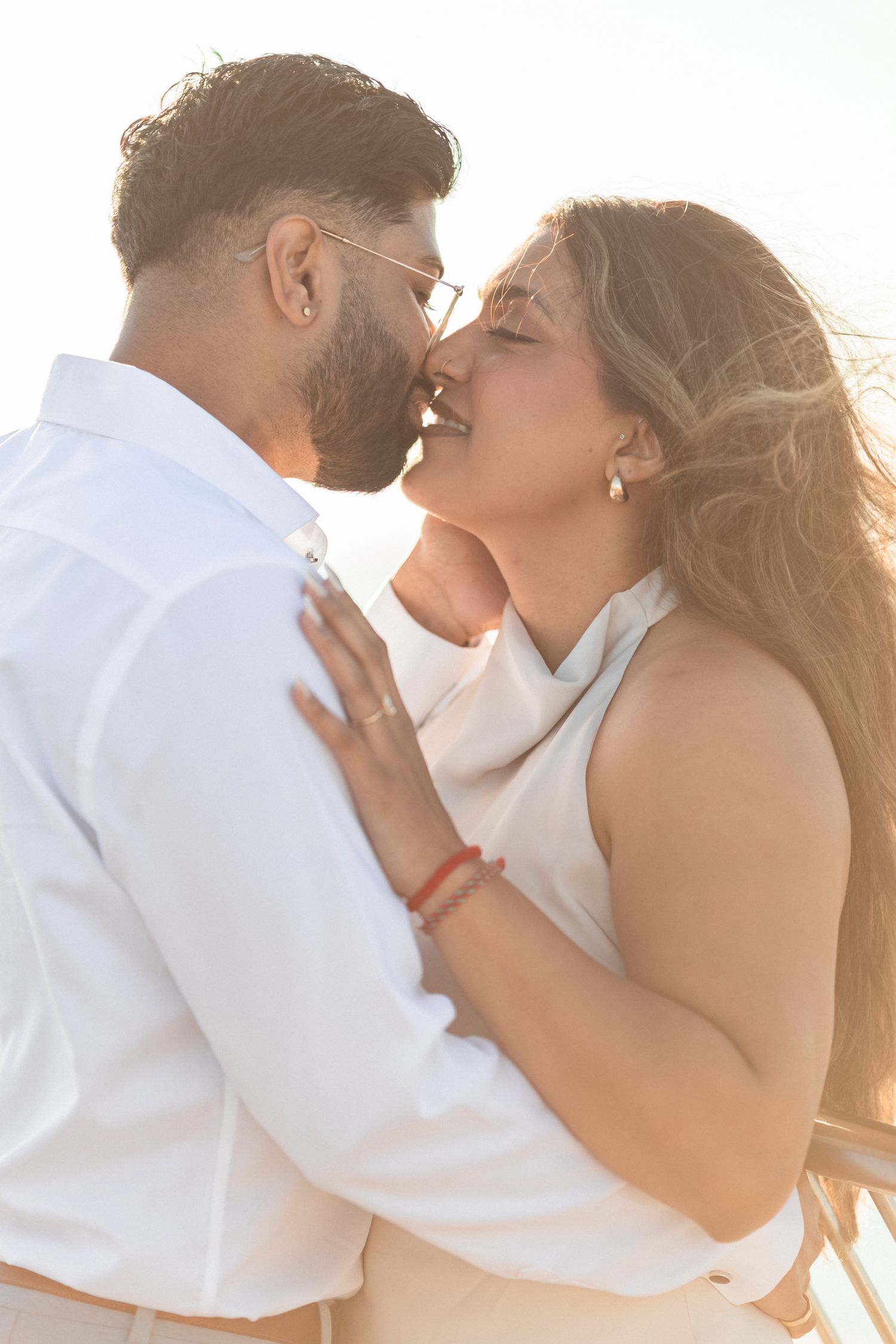 Cinematic close-up of couple kissing with the Tagus River in the background. captured by a Lisbon wedding photographer