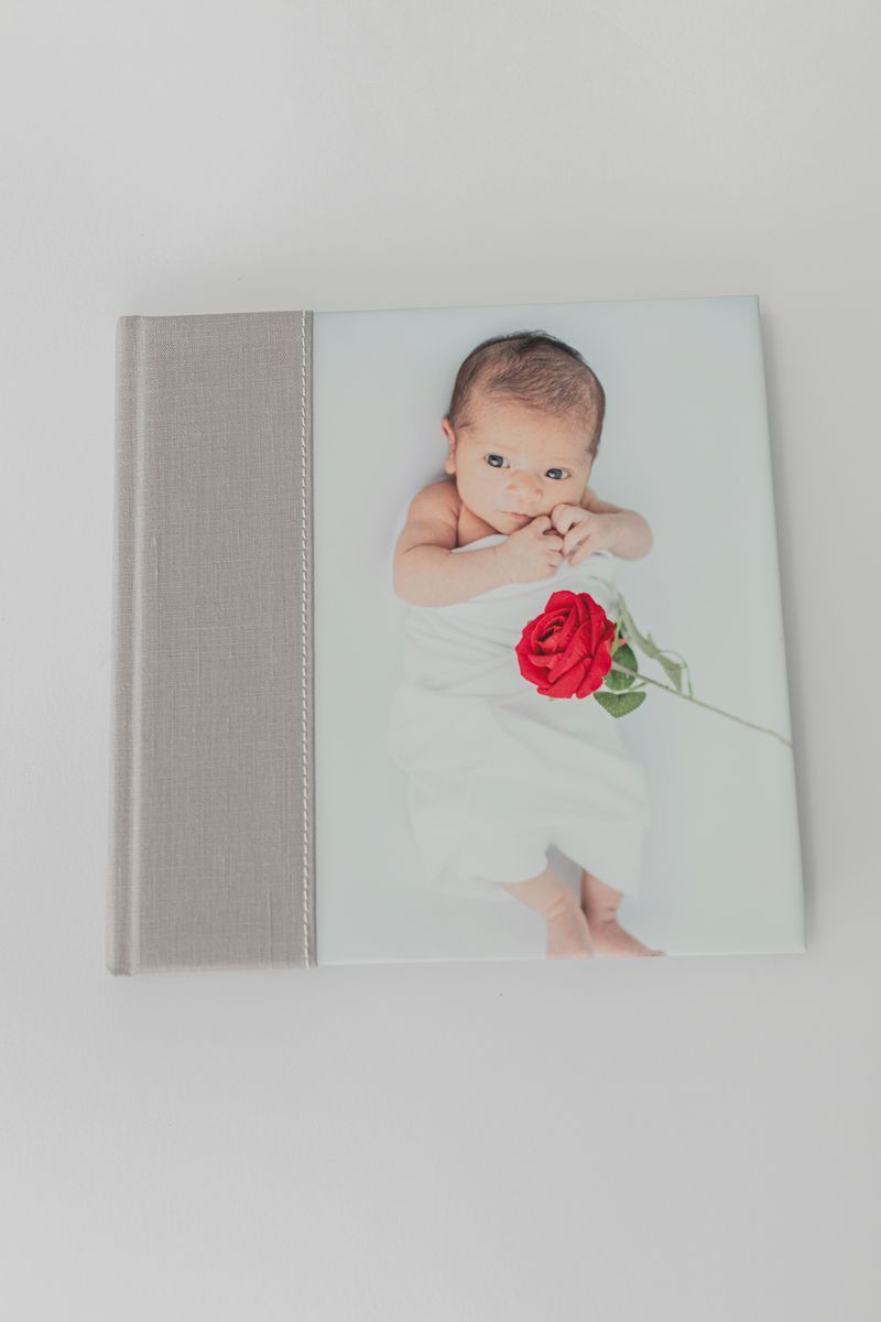 Premium 10x10 album featuring 10 spreads, smooth matte paper, oatmeal bookcloth cover, and textured white endleaves for a refined touch.