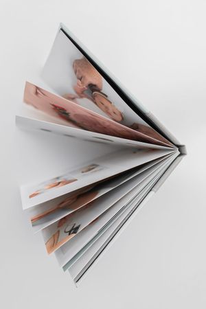 Showcase your memories in a 10x10 album with 10 spreads, oatmeal bookcloth cover, and smooth matte pages, perfect for any occasion.