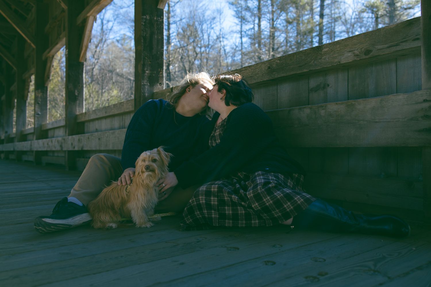 LGBTQ couple holding hands after romantic proposal at blue ridge mountain overlook near Asheville, North Carolina