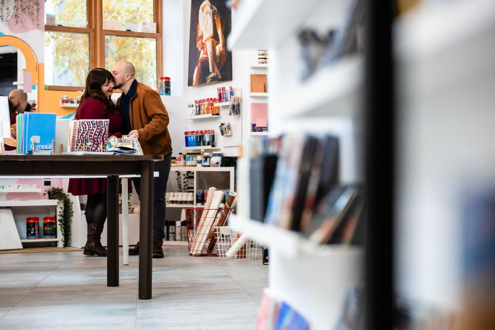 A couple browses books together in a cozy bookstore interior.