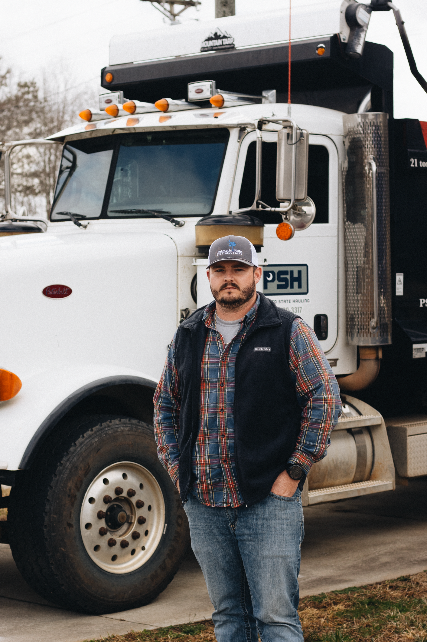 White commercial truck with PSH branding parked in outdoor setting.
