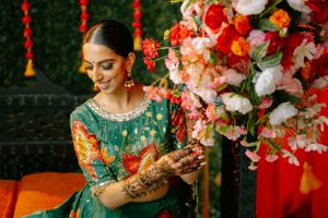 Traditional Indian wedding setup with colorful floral arrangements and elegant bridal attire.