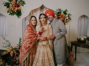 Traditional Indian wedding celebration with bright floral decor and family members in formal ethnic attire.