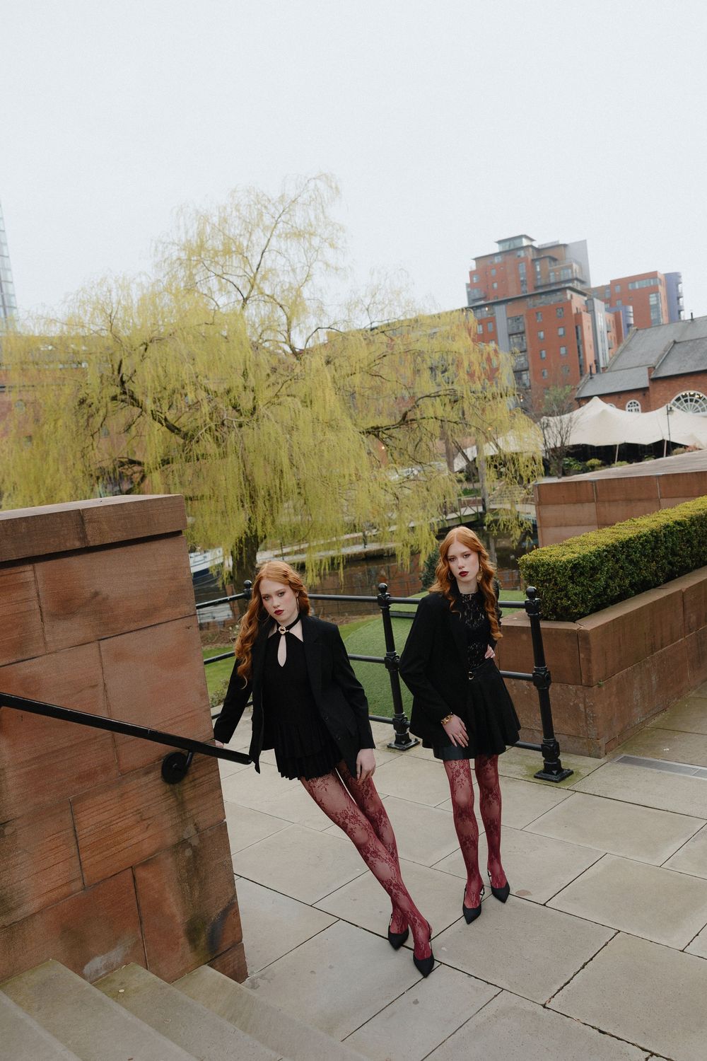 A sequence of playful jumping poses on an urban rooftop with brick walls and willow trees in the background.