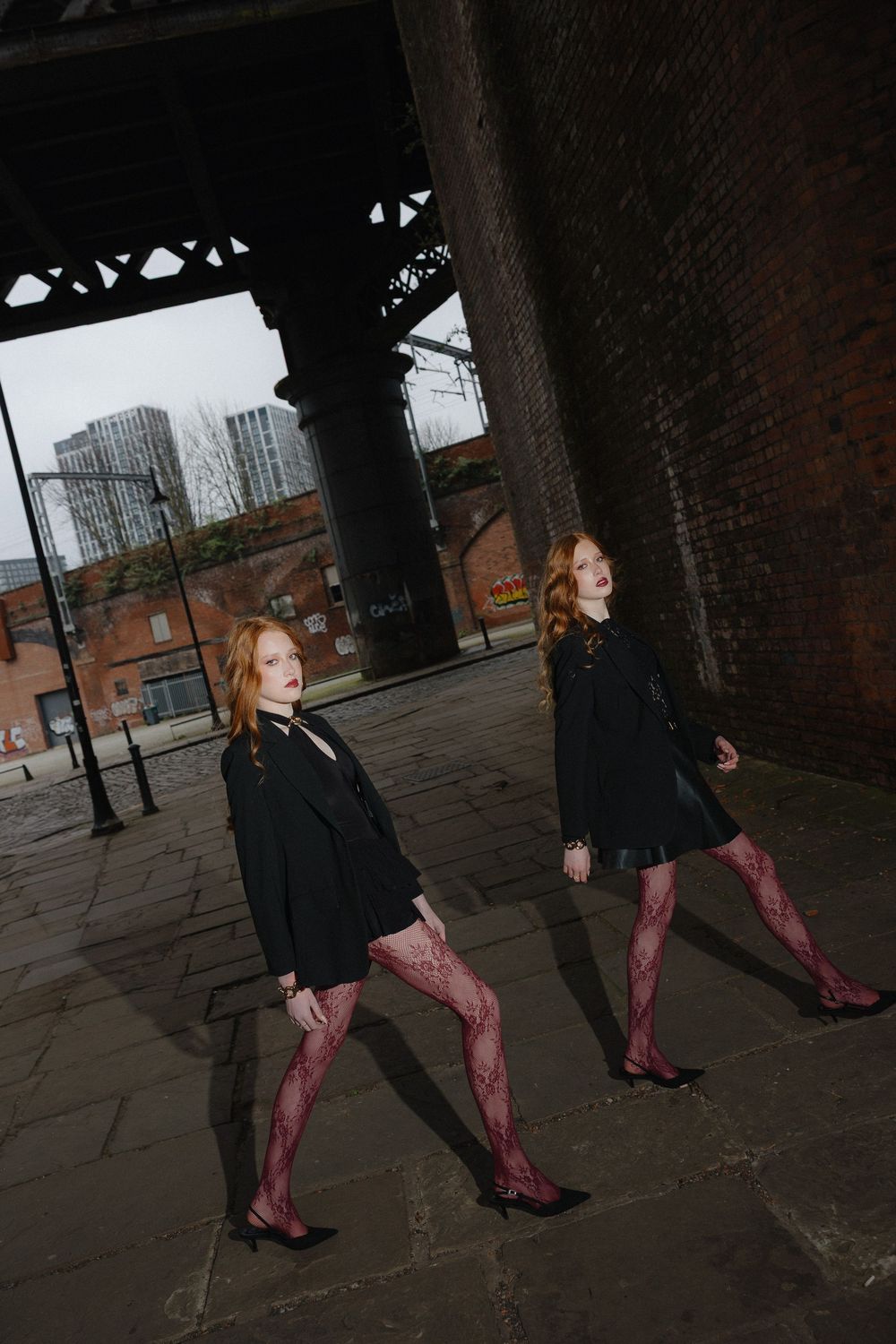 A sequence of photos showing a person in a black coat and burgundy boots walking through an industrial brick archway.