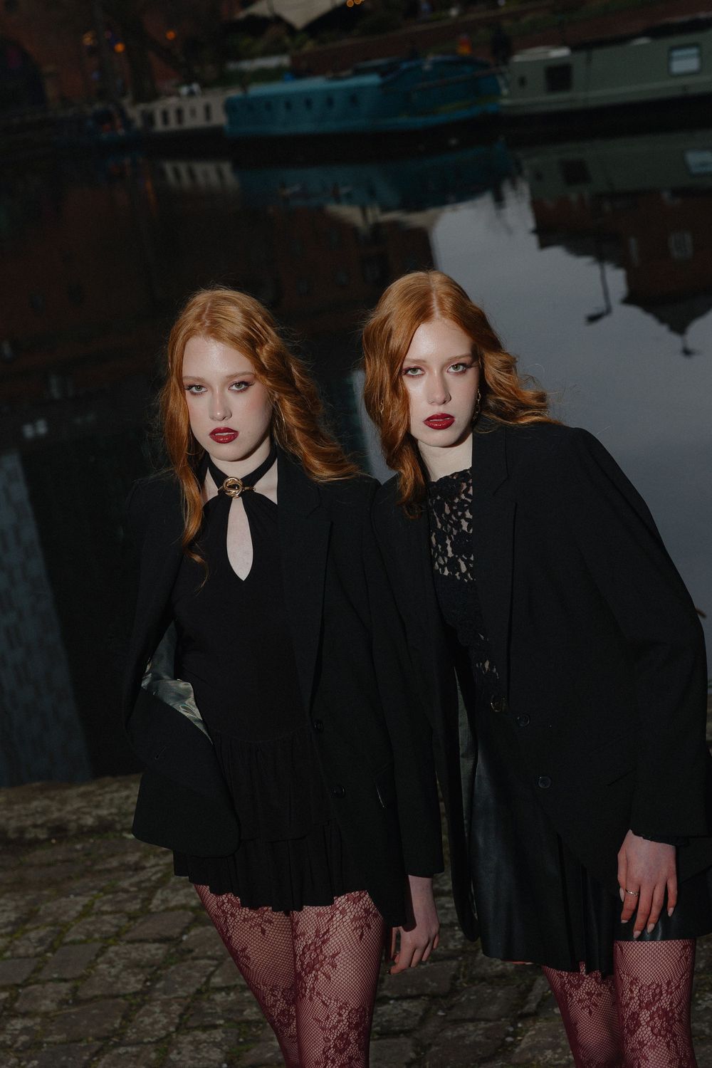 Dramatic fashion photo series showing dark gothic styling against an industrial waterfront setting.