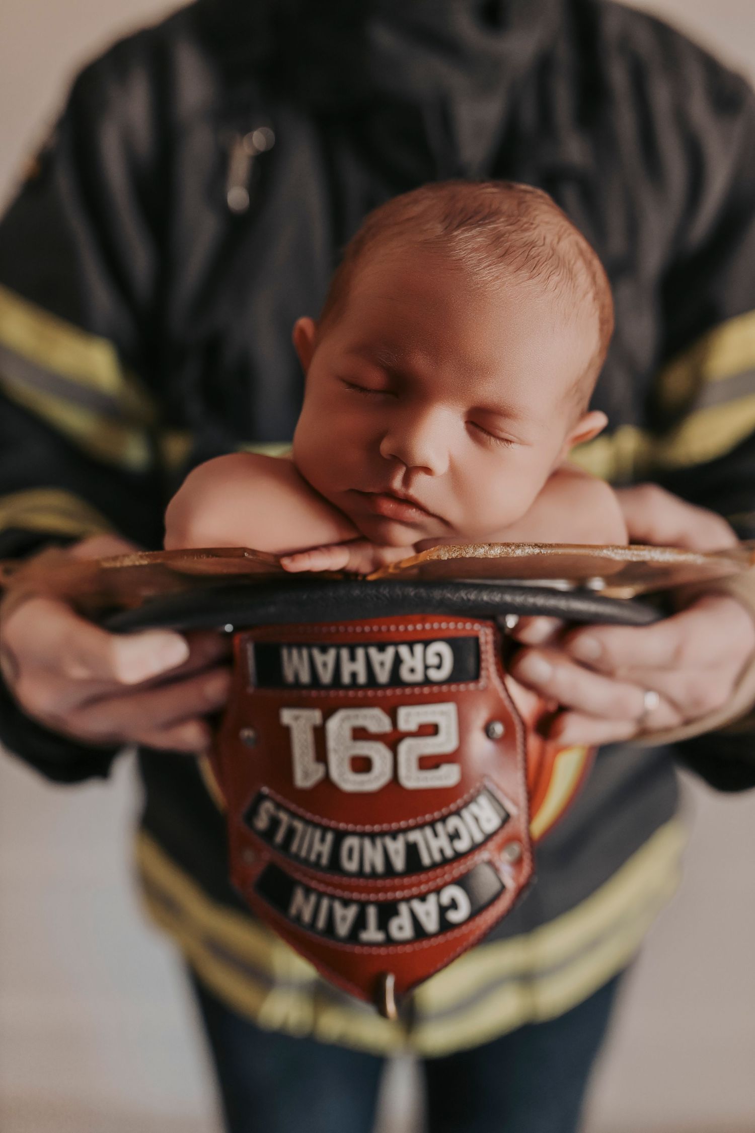 Newborn baby peacefully resting in a neutral-toned setup during a high-end studio session in Denton, Texas