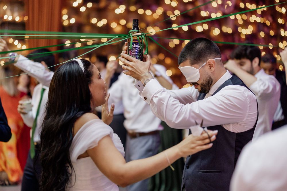 Couples dancing together at a wedding reception with warm lighting and festive atmosphere.