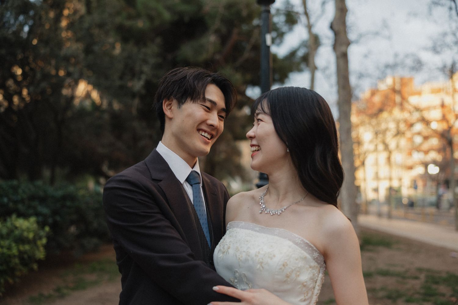 A romantic wedding photo series showing couples in formal attire embracing outdoors during golden hour lighting.