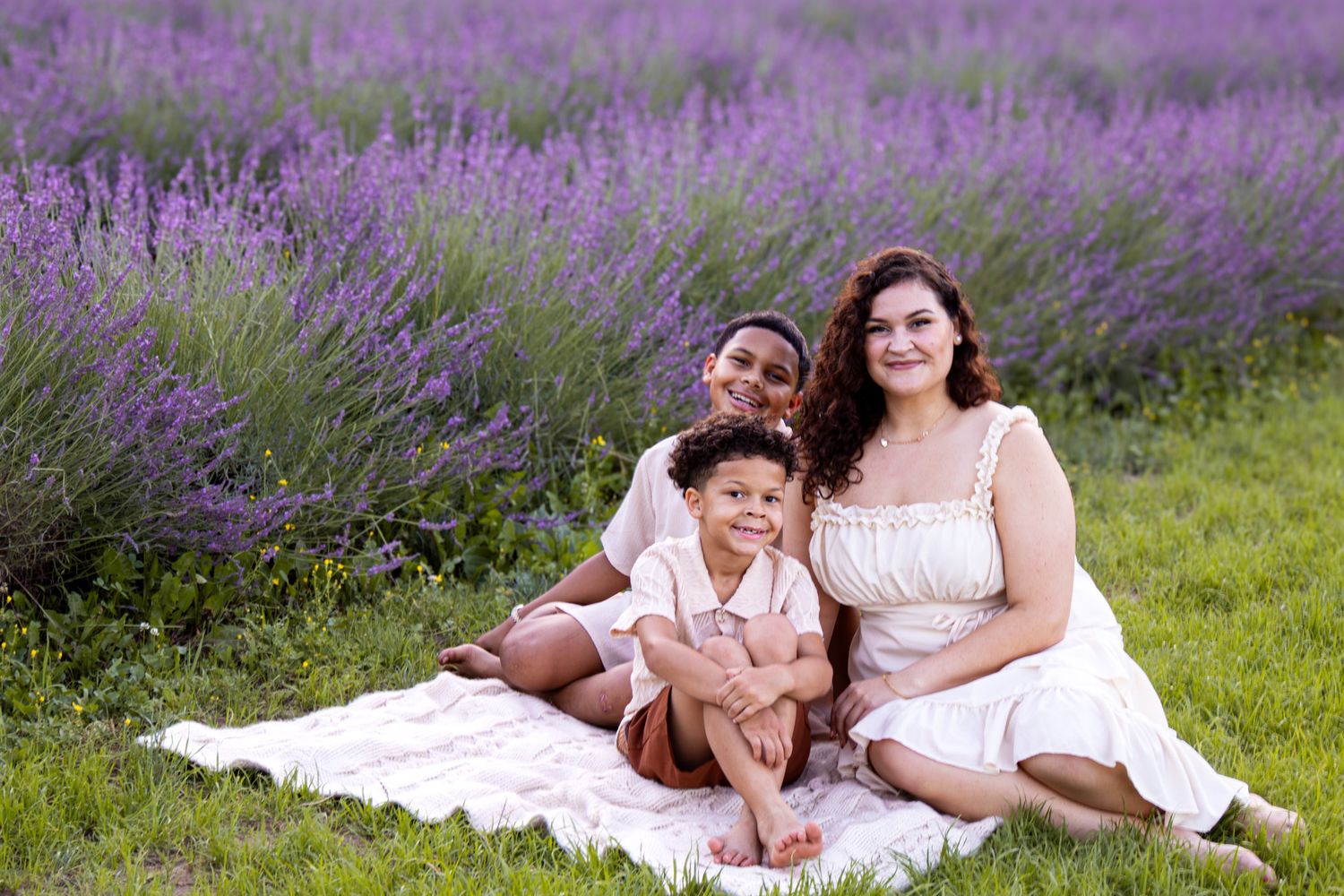 family sitting on blanket