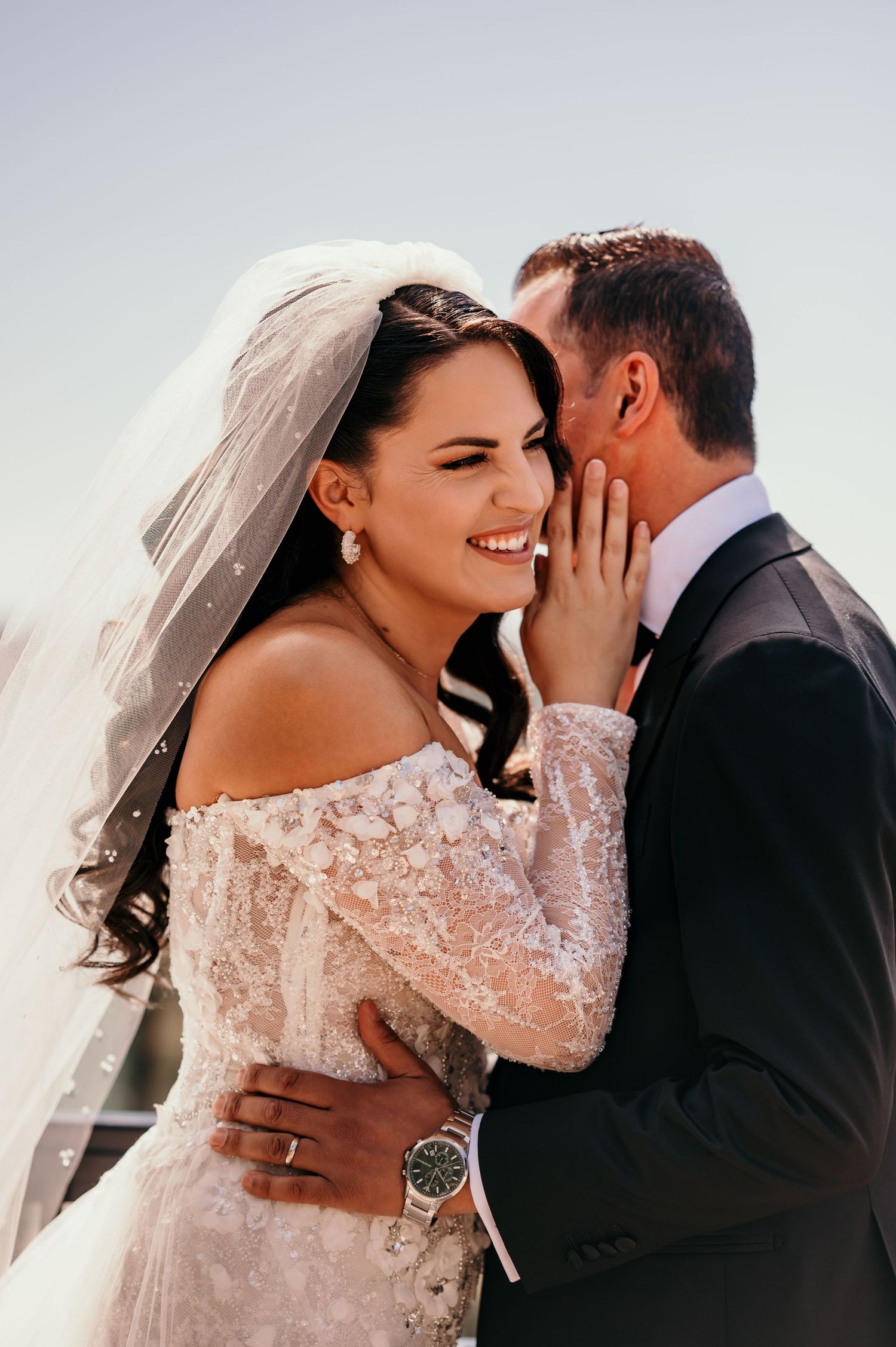 Romantic wedding photo series showing intimate moments between newlyweds in lace dress and black suit.