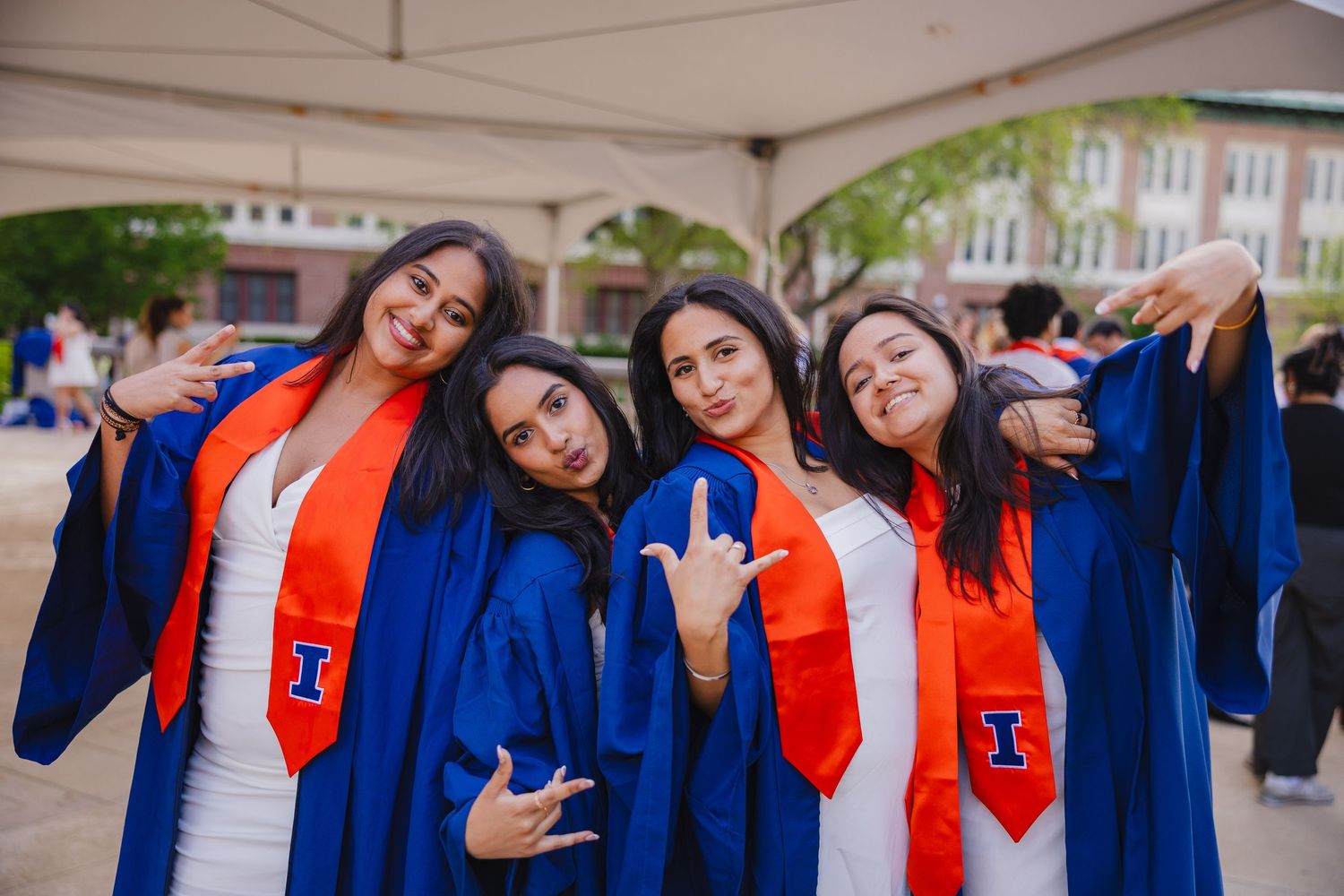 A group of graduating student friends at Foellinger doing a fun pose