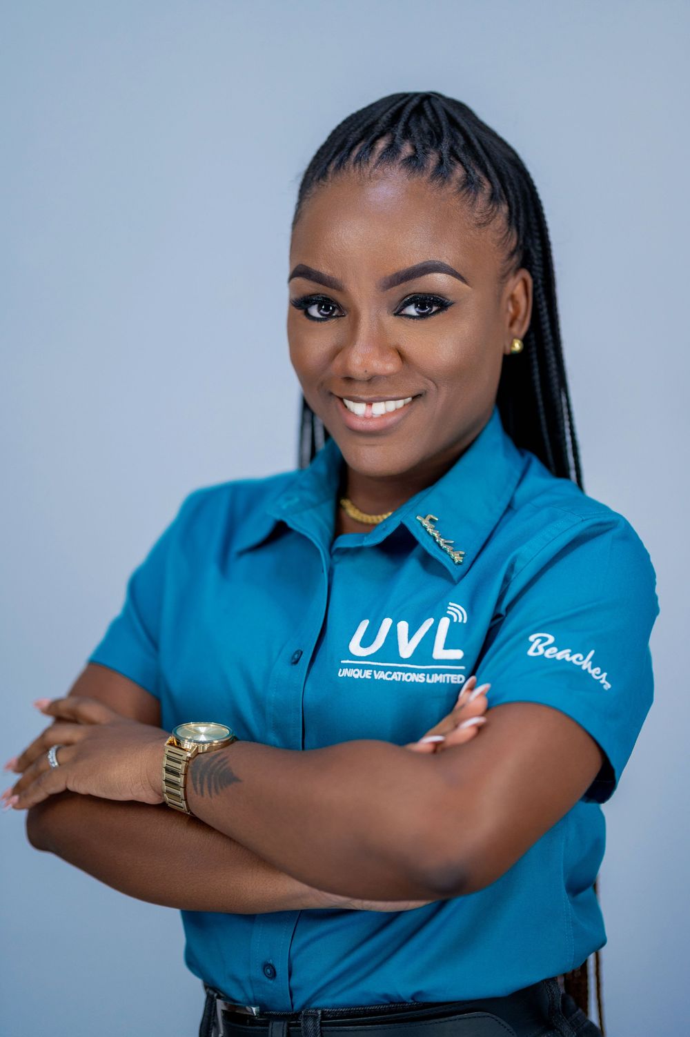 Professional portrait series showing someone in a bright blue company polo shirt posing with crossed arms and warm expressions.