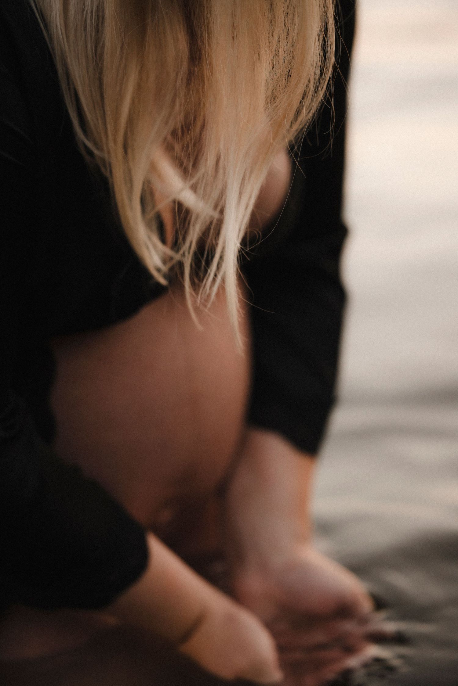 Close-up sequence of blonde hair strands against a dark background creating an artistic abstract pattern.